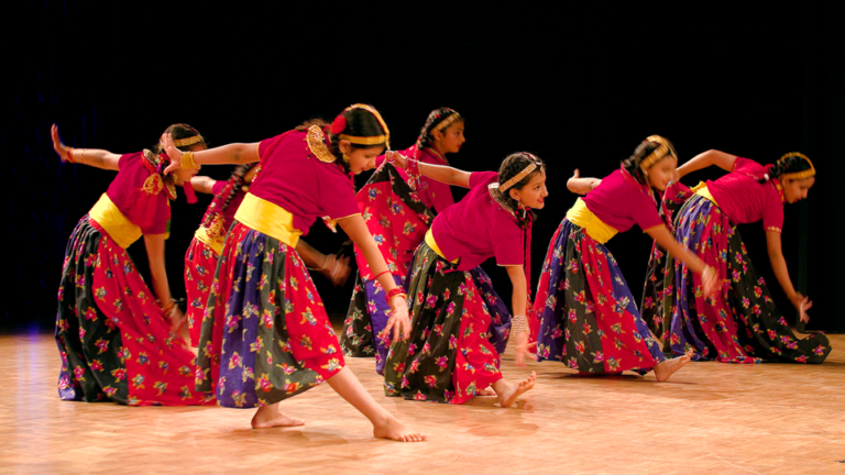 children dancing in traditional Nepali dress
